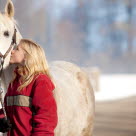 Pige kysser sin pony udenfor i sneen